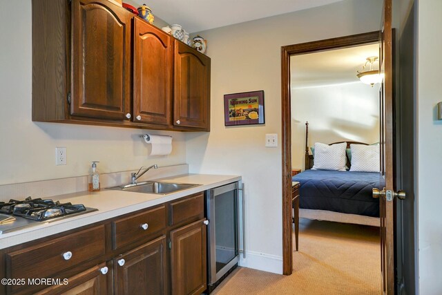 599 Point Ave, Brick, NJ 08724 - kitchen with a sink, beverage cooler, light carpet, light countertops, and stainless steel gas stovetop