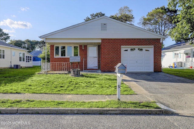 31 Togo Rd, Toms River, NJ 08757 - view of front of property with driveway, central AC unit, a front lawn, an attached garage, and brick siding