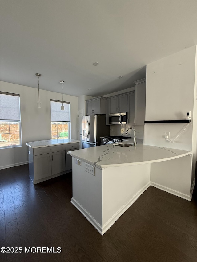 300 Prestige Rd, Brick, NJ 08723 - kitchen with stainless steel appliances, a peninsula, dark wood finished floors, baseboards, and a sink