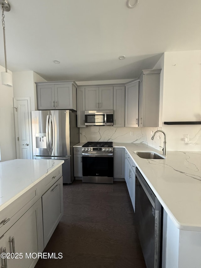 300 Prestige Rd, Brick, NJ 08723 - kitchen featuring stainless steel appliances, a sink, gray cabinets, dark wood-style floors, and tasteful backsplash