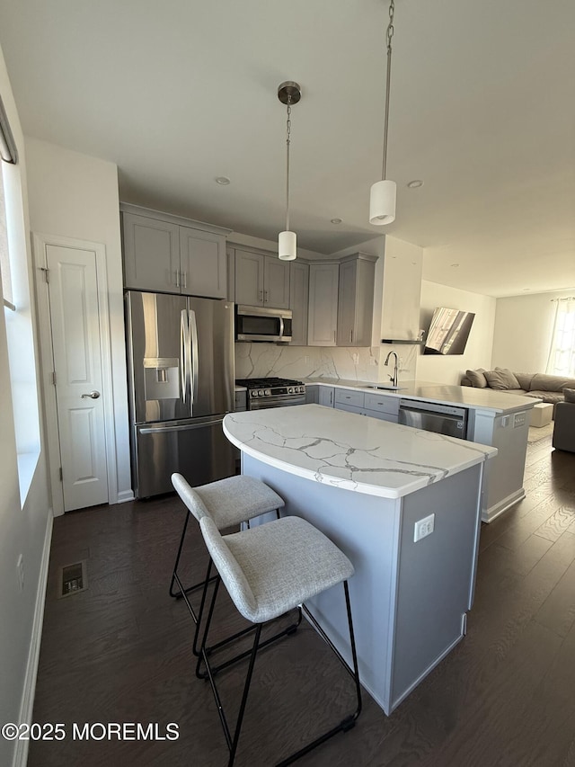 300 Prestige Rd, Brick, NJ 08723 - kitchen featuring appliances with stainless steel finishes, gray cabinetry, a sink, a center island, and open floor plan