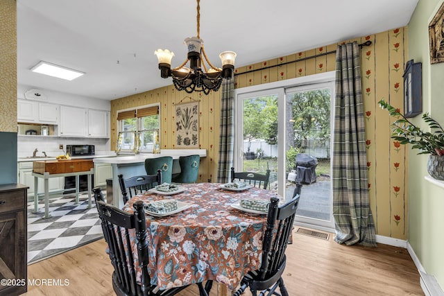 930 Devon St, Forked River, NJ 08731 - dining space with a chandelier, light wood-style flooring, wallpapered walls, and baseboards