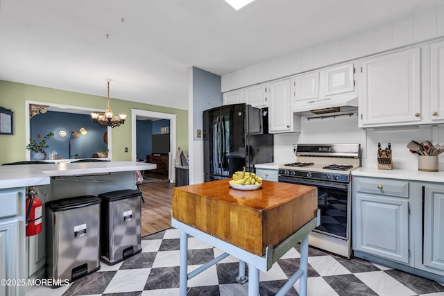 930 Devon St, Forked River, NJ 08731 - kitchen featuring white gas stove, freestanding refrigerator, under cabinet range hood, light countertops, and a chandelier