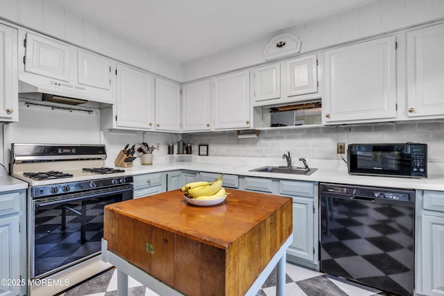 930 Devon St, Forked River, NJ 08731 - kitchen featuring black appliances, under cabinet range hood, a sink, white cabinets, and light flooring
