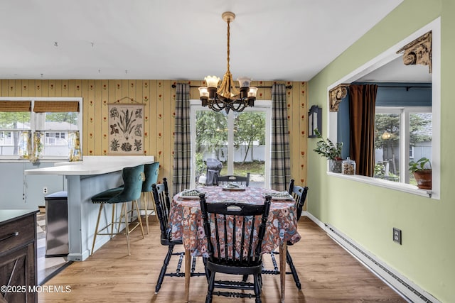 930 Devon St, Forked River, NJ 08731 - dining space featuring a baseboard radiator, a chandelier, and light wood-style flooring