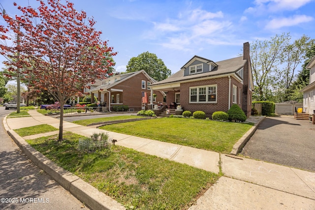 10 Fulton St, Freehold, NJ 07728 - bungalow featuring brick siding, a front lawn, and a chimney
