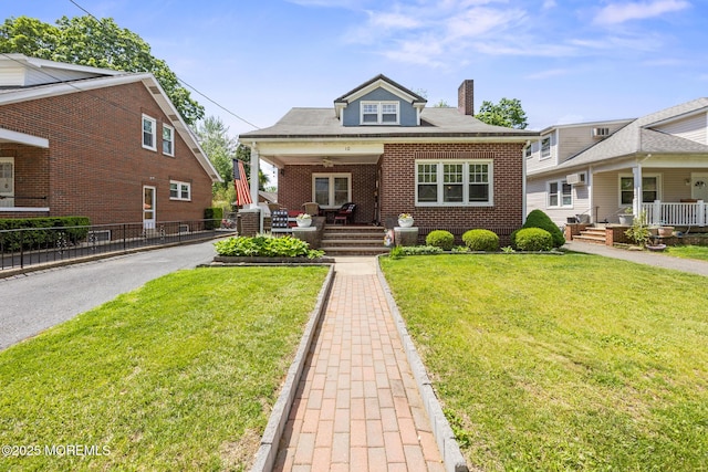 10 Fulton St, Freehold, NJ 07728 - bungalow with a porch, a chimney, brick siding, and a ceiling fan