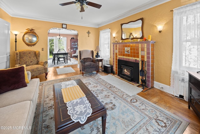 10 Fulton St, Freehold, NJ 07728 - living area with a textured wall, ornamental molding, arched walkways, ceiling fan, and wood finished floors