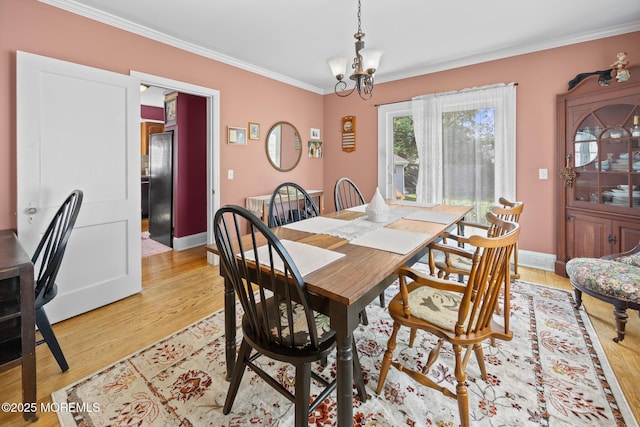 10 Fulton St, Freehold, NJ 07728 - dining area featuring crown molding, a chandelier, light wood-style floors, and baseboards