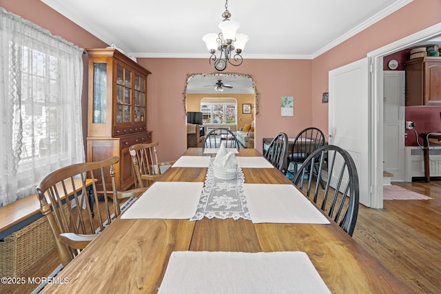 10 Fulton St, Freehold, NJ 07728 - dining space featuring radiator, a ceiling fan, a chandelier, wood finished floors, and crown molding
