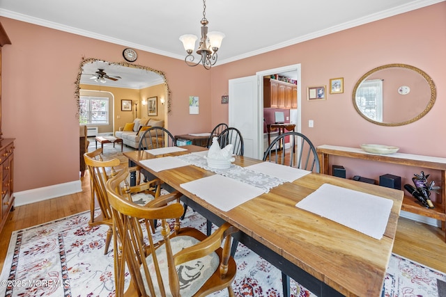 10 Fulton St, Freehold, NJ 07728 - dining area with crown molding, wood finished floors, baseboards, a chandelier, and arched walkways