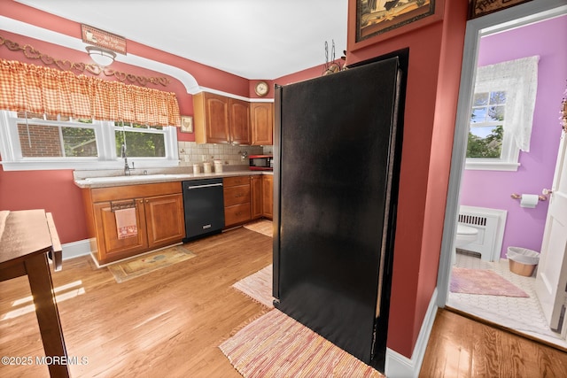 10 Fulton St, Freehold, NJ 07728 - kitchen featuring black appliances, a sink, light wood finished floors, and light countertops
