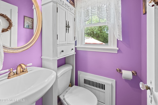 10 Fulton St, Freehold, NJ 07728 - bathroom with radiator heating unit, a sink, and toilet