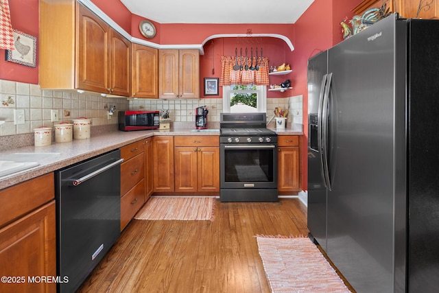 10 Fulton St, Freehold, NJ 07728 - kitchen featuring stainless steel refrigerator with ice dispenser, range with gas stovetop, dishwashing machine, brown cabinets, and light wood-style flooring