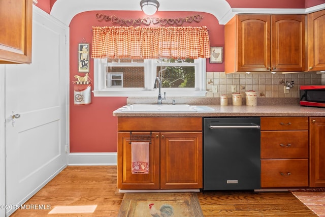 10 Fulton St, Freehold, NJ 07728 - kitchen featuring a sink, dishwasher, wood finished floors, baseboards, and brown cabinetry
