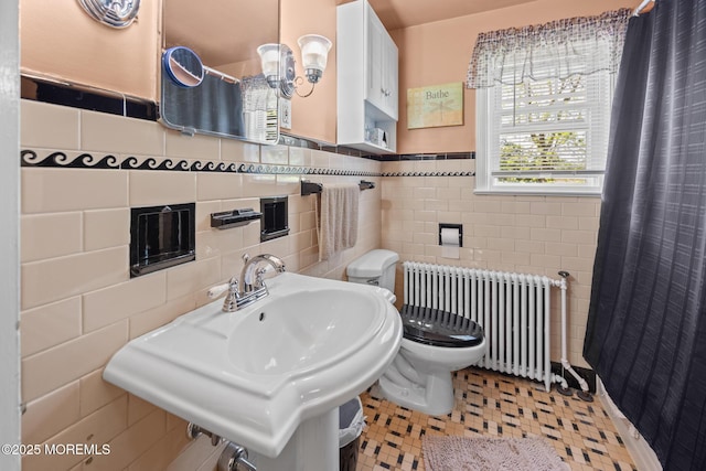 10 Fulton St, Freehold, NJ 07728 - bathroom featuring radiator, tile walls, toilet, a sink, and wainscoting