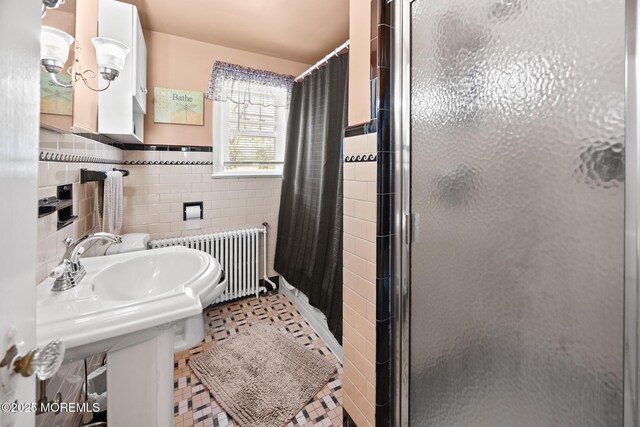 10 Fulton St, Freehold, NJ 07728 - full bathroom with radiator, a stall shower, tile walls, and a wainscoted wall