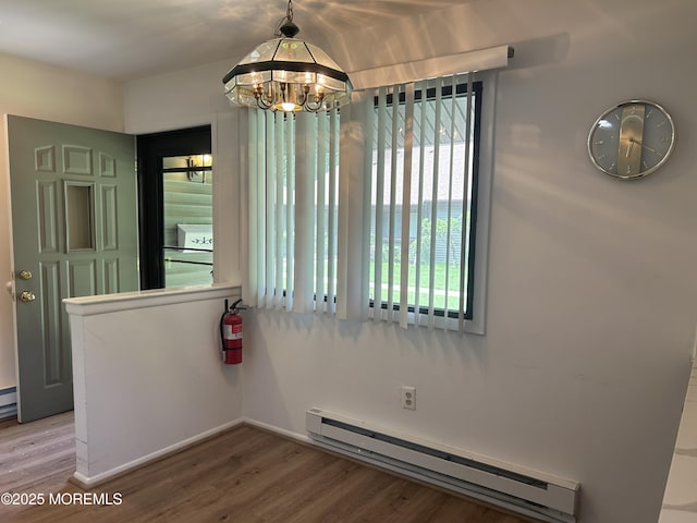 12 Medford Ct, Red Bank, NJ 07701 - unfurnished room featuring baseboard heating, a chandelier, wood finished floors, and baseboards