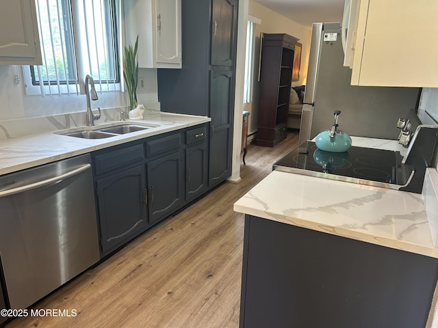12 Medford Ct, Red Bank, NJ 07701 - kitchen with appliances with stainless steel finishes, a sink, light wood finished floors, and light stone counters
