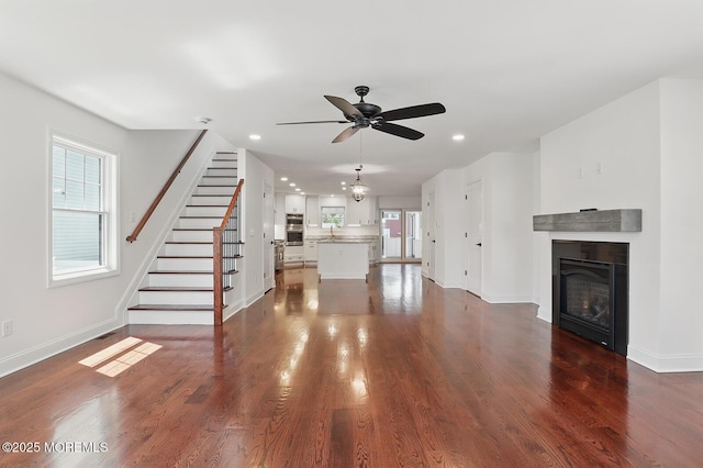 18 Neptune Pl, North Middletown, NJ 07748 - unfurnished living room with a ceiling fan, baseboards, a fireplace, recessed lighting, and stairs