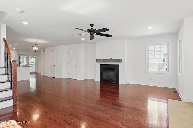 18 Neptune Pl, North Middletown, NJ 07748 - unfurnished living room featuring stairway, a glass covered fireplace, recessed lighting, wood finished floors, and baseboards