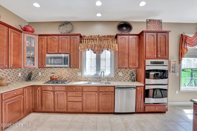 7 Jester Ct, Monroe, NJ 08831 - kitchen with appliances with stainless steel finishes, light stone countertops, tasteful backsplash, glass insert cabinets, and recessed lighting