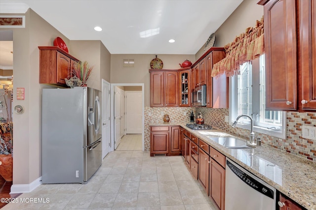 7 Jester Ct, Monroe, NJ 08831 - kitchen featuring stainless steel appliances, a sink, light stone countertops, backsplash, and glass insert cabinets