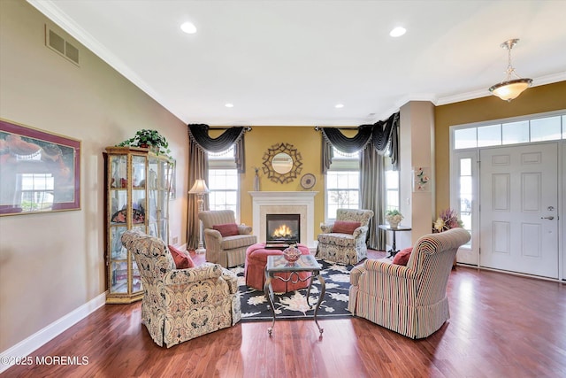 7 Jester Ct, Monroe, NJ 08831 - living area with ornamental molding, a glass covered fireplace, wood finished floors, baseboards, and recessed lighting
