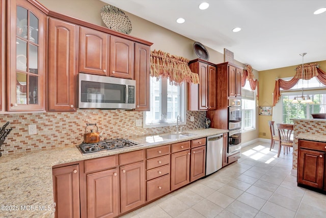 7 Jester Ct, Monroe, NJ 08831 - kitchen featuring appliances with stainless steel finishes, a sink, glass insert cabinets, decorative backsplash, and baseboards