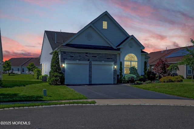 7 Jester Ct, Monroe, NJ 08831 - traditional-style house with driveway, a front lawn, stone siding, central AC unit, and a garage