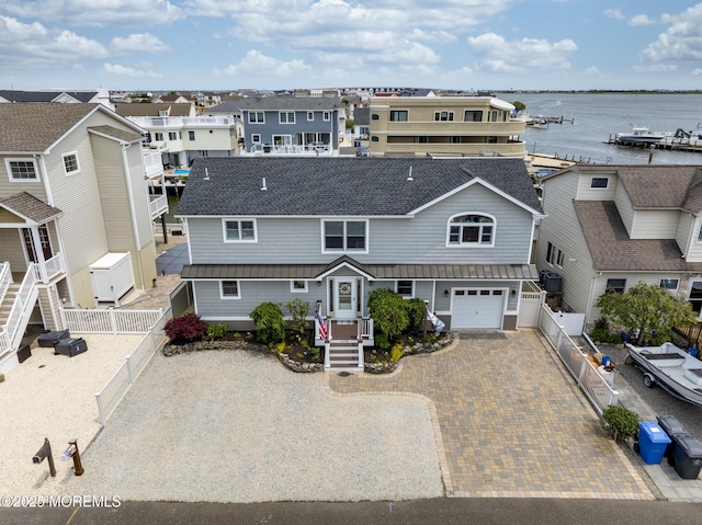1498 Paul Blvd, Manahawkin, NJ 08050 - view of front of property featuring decorative driveway, a garage, roof with shingles, a residential view, and a water view