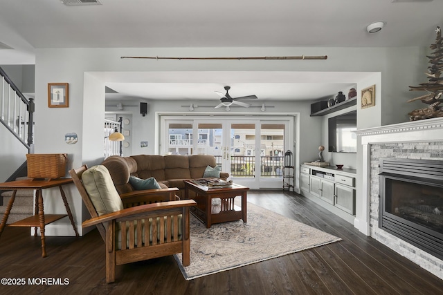 1498 Paul Blvd, Manahawkin, NJ 08050 - living room featuring a fireplace, ceiling fan, stairway, dark wood-style floors, and plenty of natural light