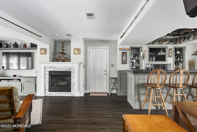 1498 Paul Blvd, Manahawkin, NJ 08050 - living area with bar with sink, a fireplace, and dark wood-style flooring