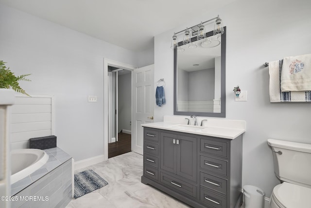1498 Paul Blvd, Manahawkin, NJ 08050 - full bath with a garden tub, toilet, vanity, marble finish floors, and baseboards