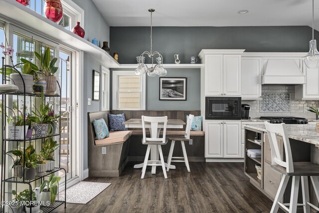 1498 Paul Blvd, Manahawkin, NJ 08050 - kitchen with breakfast area, black microwave, custom exhaust hood, and white cabinets