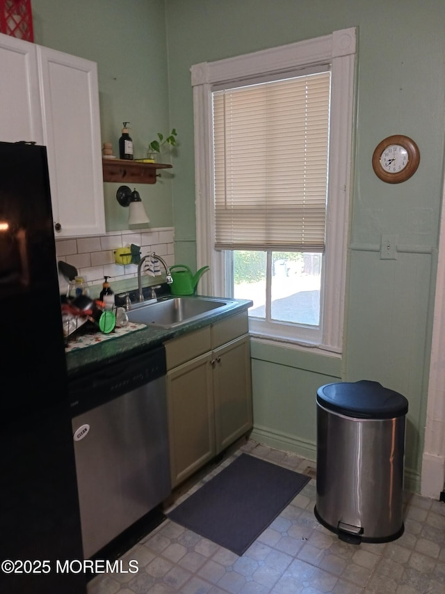 kitchen with dishwasher, a sink, freestanding refrigerator, open shelves, and backsplash