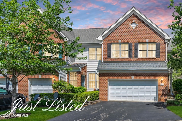 7 Hummingbird Dr, Manalapan, NJ 07726 - view of front of home featuring a garage, asphalt driveway, brick siding, and a shingled roof