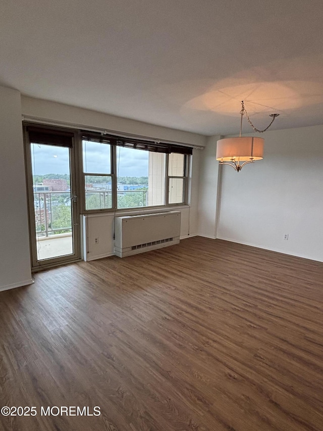 28 Riverside Ave Unit 9G, Red Bank, NJ 07701 - unfurnished room with dark wood-style floors, radiator heating unit, and healthy amount of natural light