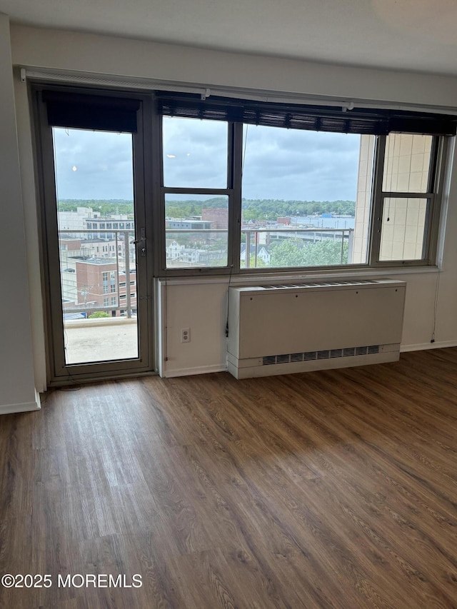 28 Riverside Ave Unit 9G, Red Bank, NJ 07701 - spare room featuring wood finished floors, baseboards, and radiator