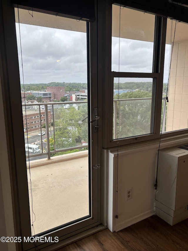 28 Riverside Ave Unit 9G, Red Bank, NJ 07701 - doorway featuring dark wood-style flooring, healthy amount of natural light, and baseboards