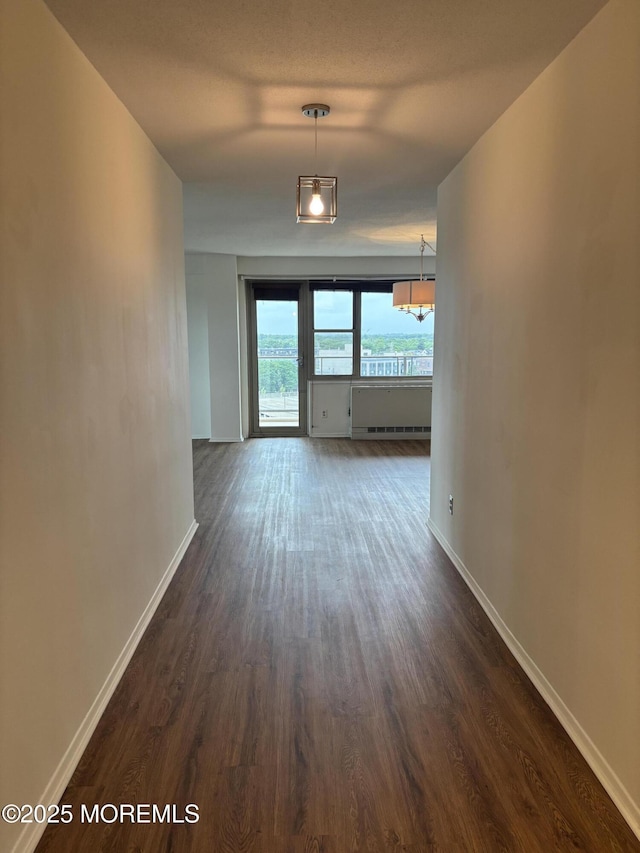 28 Riverside Ave Unit 9G, Red Bank, NJ 07701 - corridor featuring dark wood-type flooring, baseboards, and a chandelier