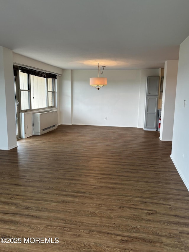 28 Riverside Ave Unit 9G, Red Bank, NJ 07701 - unfurnished room with dark wood-style floors, radiator, and baseboards
