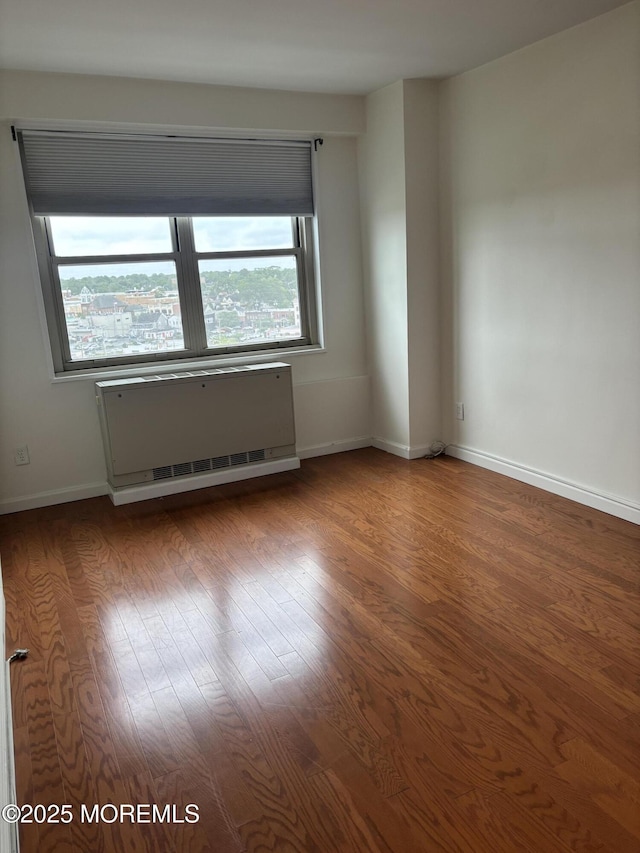 28 Riverside Ave Unit 9G, Red Bank, NJ 07701 - empty room with radiator heating unit, wood finished floors, and baseboards