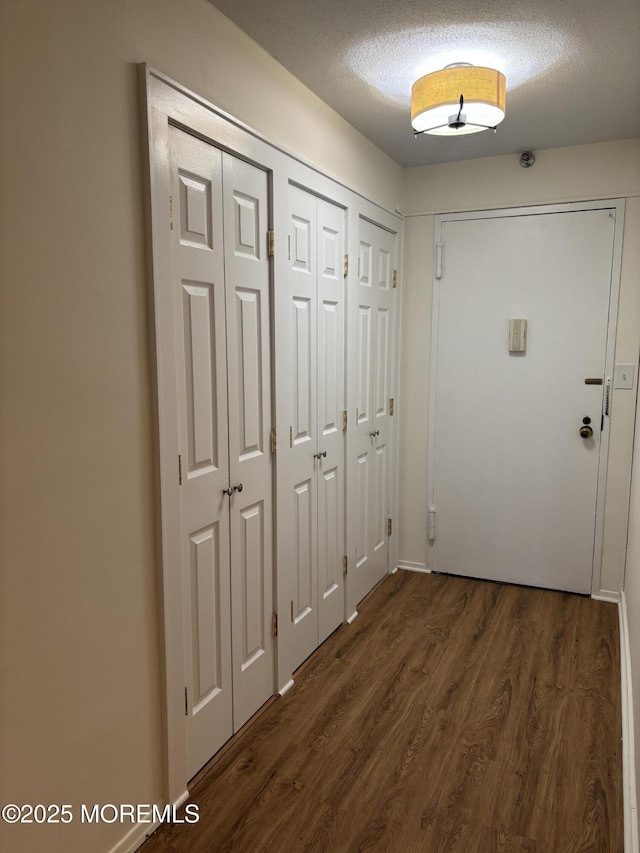 28 Riverside Ave Unit 9G, Red Bank, NJ 07701 - hall with dark wood-style floors and a textured ceiling