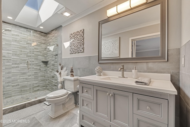 14 Sea Point Dr, Point Pleasant, NJ 08742 - bathroom featuring tile walls, toilet, vanity, a stall shower, and tile patterned floors