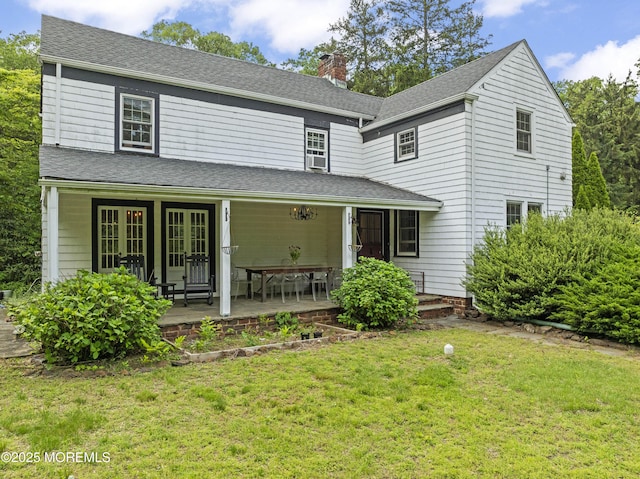 341 Chapel Hill Rd, Atlantic Highlands, NJ 07716 - view of front of property featuring a front yard, a chimney, french doors, and roof with shingles
