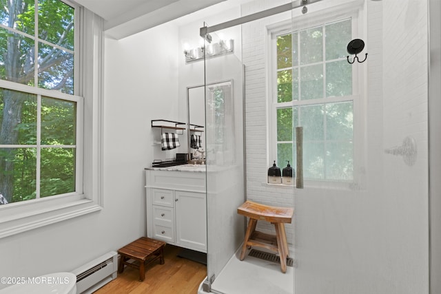 341 Chapel Hill Rd, Atlantic Highlands, NJ 07716 - bathroom with a baseboard heating unit, vanity, plenty of natural light, and wood finished floors