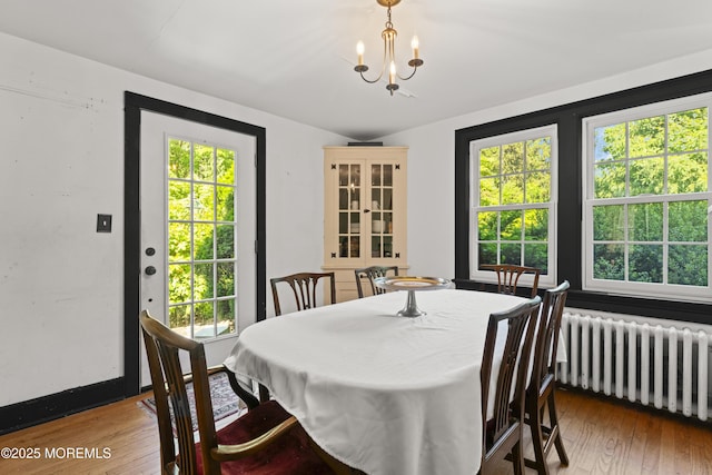 341 Chapel Hill Rd, Atlantic Highlands, NJ 07716 - dining space with radiator heating unit, plenty of natural light, and hardwood / wood-style floors