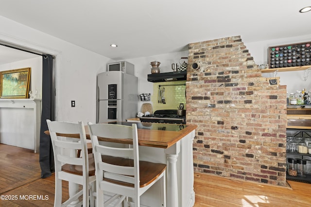 341 Chapel Hill Rd, Atlantic Highlands, NJ 07716 - kitchen with freestanding refrigerator, wood-type flooring, under cabinet range hood, and recessed lighting
