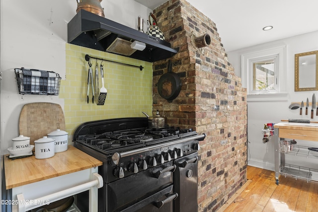 341 Chapel Hill Rd, Atlantic Highlands, NJ 07716 - kitchen with double oven range, light wood finished floors, under cabinet range hood, butcher block counters, and baseboards
